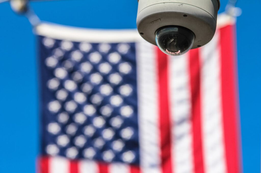 pexels-photo-97509 Surveillance camera focusing on security with American flag backdrop.